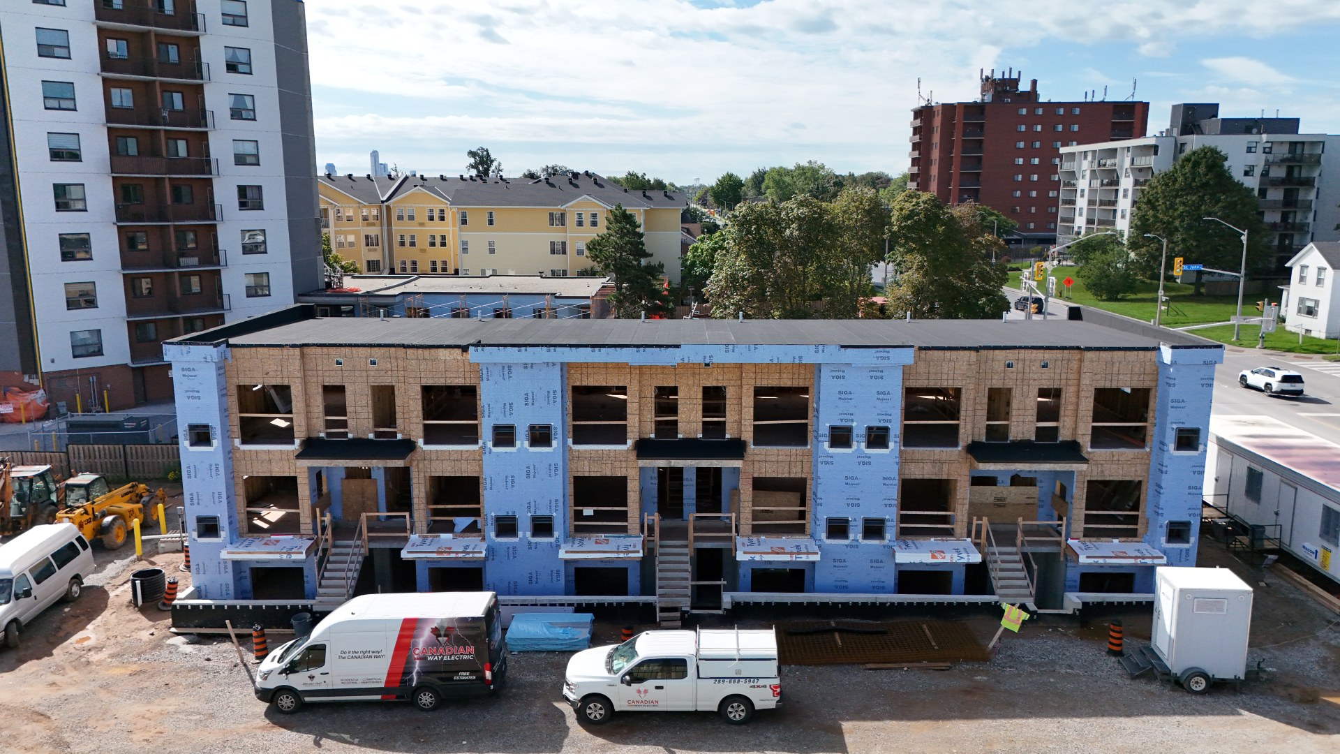 Parkside39 Apartments — Three-storey building wrapped and nearly enclosed, September 2026